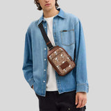 COACH Coach X Peanuts Racer Sling Pack In Signature Canvas With Snoopy Print Tan Multi CBK47