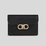 Black leather wallet with gold clasp on a light gray background