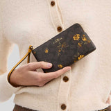 COACH Corner Zip Wristlet In Signature Canvas With Floral Print Walnut/Yellow CCL19