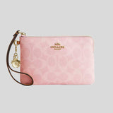 COACH Corner Zip Wristlet In Signature Canvas With Charms Powder Pink CEF72