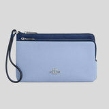 Blue Coach wristlet with a strap on a gray background